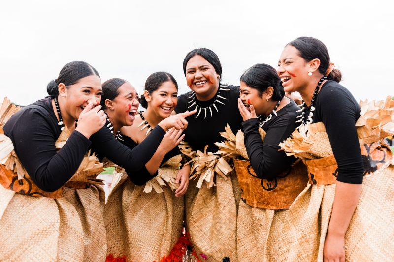 Six_Pasifika_women_in_woven_flax_skirts_laughing.jpg